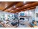 Spacious living room features wood beamed ceilings, a stone fireplace, and an abundance of natural light at 8815 Campbellton St, Douglasville, GA 30134