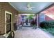 Charming covered brick patio offering a private outdoor retreat with hanging swing and access to the lush backyard at 8815 Campbellton St, Douglasville, GA 30134
