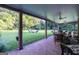 Spacious covered brick patio providing comfortable seating and a great view of the lush, expansive backyard at 8815 Campbellton St, Douglasville, GA 30134