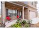 Inviting front porch with stylish seating and well-manicured landscaping and attached two-car garage at 2277 Church St, Hampton, GA 30228
