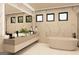 This bathroom features white marble counters, a soaking tub, and 3 modern windows at 3181 Buck Branch Rd, Conyers, GA 30094
