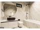 A luxury bathroom offers modern finishes with marble walls, a large, round mirror, and a soaking tub at 3181 Buck Branch Rd, Conyers, GA 30094