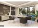Contemporary dining room featuring unique light fixture, elegant decor and views into the backyard and pool at 3181 Buck Branch Rd, Conyers, GA 30094