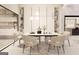 Elegant dining room with modern light fixture, seating for six, and views into the kitchen at 3181 Buck Branch Rd, Conyers, GA 30094