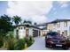 A modern, two-story home boasts a well-maintained lawn with manicured bushes and a circular drive at 3181 Buck Branch Rd, Conyers, GA 30094