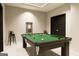 This is a modern game room that features a full-sized billiard table on top of a marble floor at 3181 Buck Branch Rd, Conyers, GA 30094