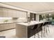 This kitchen features stone countertops, modern appliances, an eat-in island, and views of the pool at 3181 Buck Branch Rd, Conyers, GA 30094
