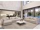 Bright and airy living room with sleek furniture, a large rug, and oversized sliding glass doors to the pool at 3181 Buck Branch Rd, Conyers, GA 30094