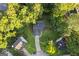 Aerial shot of the home surrounded by lush trees and a well-maintained yard at 5368 Nw Stafford Nw Dr, Lilburn, GA 30047