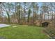 Private backyard featuring lush lawn and mature trees, providing a peaceful and secluded outdoor retreat at 5368 Nw Stafford Nw Dr, Lilburn, GA 30047