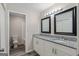 Modern bathroom features a double sink vanity with granite countertop and stylish mirrors at 5368 Nw Stafford Nw Dr, Lilburn, GA 30047
