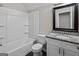 Well-lit bathroom with tub, toilet, and vanity featuring granite countertops at 5368 Nw Stafford Nw Dr, Lilburn, GA 30047