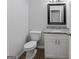 Neat bathroom features a granite vanity, mirror, and new toilet at 5368 Nw Stafford Nw Dr, Lilburn, GA 30047