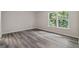 Bright bedroom featuring natural light and neutral walls and modern vinyl plank flooring at 5368 Nw Stafford Nw Dr, Lilburn, GA 30047