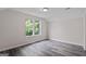 Bright bedroom with large window offers a beautiful green view and wood-look flooring at 5368 Nw Stafford Nw Dr, Lilburn, GA 30047