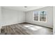 Spacious bedroom with wood-look flooring, large windows, and neutral colors at 5368 Nw Stafford Nw Dr, Lilburn, GA 30047