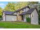Charming home showcasing stone accents, gray siding, and a neatly maintained front lawn at 5368 Nw Stafford Nw Dr, Lilburn, GA 30047