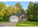 Charming home featuring stone accents, gray siding, and mature trees surrounding the property at 5368 Nw Stafford Nw Dr, Lilburn, GA 30047