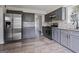 Updated kitchen featuring gray cabinets, stainless steel appliances, and a tiled backsplash at 5368 Nw Stafford Nw Dr, Lilburn, GA 30047