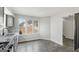 Bright kitchen boasts stainless appliances, granite counters, backsplash, and a view of the backyard through large windows at 5368 Nw Stafford Nw Dr, Lilburn, GA 30047