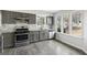 Updated kitchen featuring stainless steel appliances, subway tile backsplash, and bright natural light through large windows at 5368 Nw Stafford Nw Dr, Lilburn, GA 30047