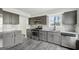 Updated kitchen featuring gray cabinets, subway tile backsplash, stainless steel appliances, and granite countertops at 5368 Nw Stafford Nw Dr, Lilburn, GA 30047