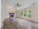 Bright and airy living room with a cozy fireplace, large windows, and vinyl plank flooring at 5368 Nw Stafford Nw Dr, Lilburn, GA 30047