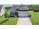 Charming single-Gathering home features a two-car garage, well-manicured lawn and inviting front porch at 104 Conway St, Peachtree City, GA 30269