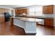 Well-designed kitchen boasting a spacious island, stainless appliances and wooden cabinets at 104 Conway St, Peachtree City, GA 30269