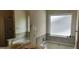 Bright bathroom featuring a double vanity, soaking tub, separate shower, and privacy window at 305 Hidden Creek Ln, Canton, GA 30114