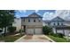 Charming two-story home featuring a two-car garage, stone accents, and well-maintained landscaping at 305 Hidden Creek Ln, Canton, GA 30114