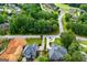 Overhead view of neighborhood with a home featuring well-kept landscaping and a lush tree line at 204 Pinehurst Way, Carrollton, GA 30116