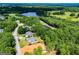 Aerial view of the home's setting near a picturesque lake and lush green landscape at 204 Pinehurst Way, Carrollton, GA 30116