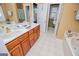 Bathroom features double vanity, soaking tub, and access to a walk-in closet for ample storage at 204 Pinehurst Way, Carrollton, GA 30116