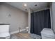 Bathroom features a toilet, a shower with a dark shower curtain and new floors at 204 Pinehurst Way, Carrollton, GA 30116