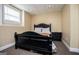 Comfortable bedroom with neutral paint, a dark bed frame, and plush carpeting at 204 Pinehurst Way, Carrollton, GA 30116