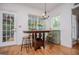Breakfast area with hardwood floors, table with stools, chandelier, and french doors at 204 Pinehurst Way, Carrollton, GA 30116