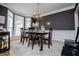 Elegant dining room with a bay window, chandelier, and wainscoting, perfect for entertaining guests at 204 Pinehurst Way, Carrollton, GA 30116