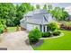Gray two-story home featuring an attached two-car garage, landscaped yard, and private driveway at 204 Pinehurst Way, Carrollton, GA 30116