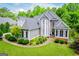 Charming two-story home with gray siding, black shutters, a well-manicured lawn, and front garden at 204 Pinehurst Way, Carrollton, GA 30116