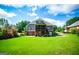 Rear exterior view shows covered deck and lawn at 204 Pinehurst Way, Carrollton, GA 30116
