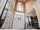 Elegant foyer with a high ceiling, chandelier, decorative front door, and views into the dining room at 204 Pinehurst Way, Carrollton, GA 30116