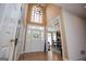 Elegant foyer with a high ceiling, chandelier, decorative front door, and views into the dining room at 204 Pinehurst Way, Carrollton, GA 30116