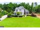 Aerial view of beautiful home with manicured front lawn and mature landscaping at 204 Pinehurst Way, Carrollton, GA 30116