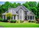 Charming two-story home featuring mature landscaping, a manicured lawn, and a welcoming front porch at 204 Pinehurst Way, Carrollton, GA 30116