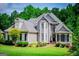 Charming two-story home featuring mature landscaping, a manicured lawn, and a welcoming front porch at 204 Pinehurst Way, Carrollton, GA 30116