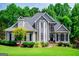 Charming two-story home featuring mature landscaping, a manicured lawn, and a welcoming front porch at 204 Pinehurst Way, Carrollton, GA 30116