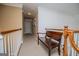 Second-floor hallway featuring a wooden bench, carpeted floor, and white-painted railings for a clean look at 204 Pinehurst Way, Carrollton, GA 30116