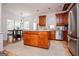 Open concept kitchen features a center island, stainless steel appliances, and natural light at 204 Pinehurst Way, Carrollton, GA 30116
