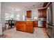 Bright open kitchen features a center island, stainless steel appliances, and hardwood floors at 204 Pinehurst Way, Carrollton, GA 30116